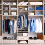 Big wardrobe with male clothes for dressing room