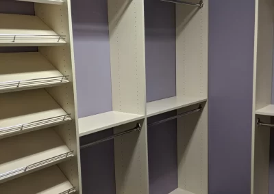 Custom Walk-in Closet with Triple Hanging Space and Abundant Shoe Storage.