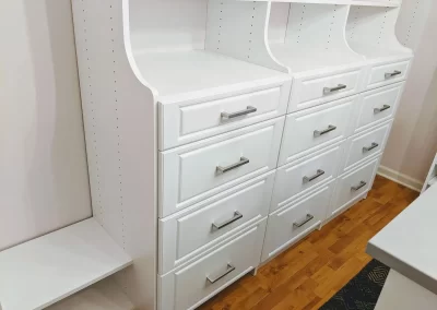 White Custom Closet System With Raised Paned Drawer Fronts