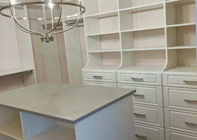 Island In Front of White Custom Closet System