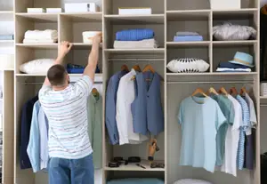 man reaching into box wardrobe shelf